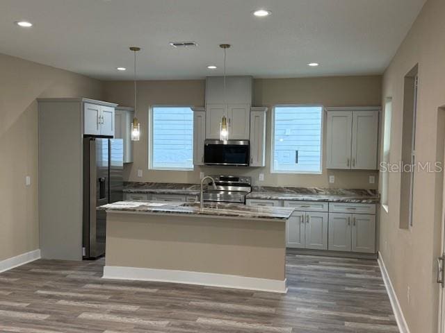 2404 Cassell St, Tampa, FL 33605 - kitchen featuring appliances with stainless steel finishes, plenty of natural light, wood finished floors, and recessed lighting