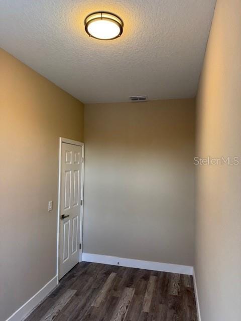 2404 Cassell St, Tampa, FL 33605 - spare room featuring a textured ceiling and dark wood finished floors