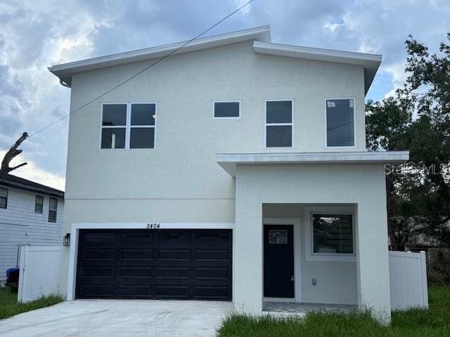 2404 Cassell St, Tampa, FL 33605 - modern home with an attached garage, concrete driveway, and stucco siding