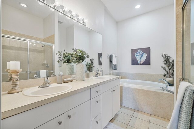 2537 Stanhope Dr, New Port Richey, FL 34655 - bathroom with double vanity, tile patterned floors, a bath, a stall shower, and recessed lighting