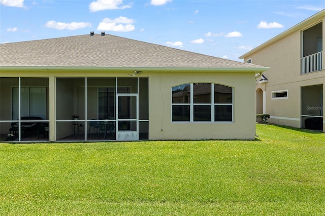 2537 Stanhope Dr, New Port Richey, FL 34655 - back of house with a yard, a sunroom, stucco siding, and roof with shingles