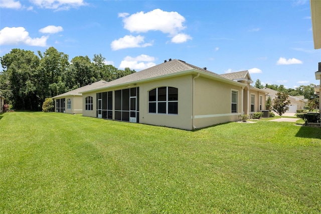 2537 Stanhope Dr, New Port Richey, FL 34655 - rear view of property featuring a yard and stucco siding