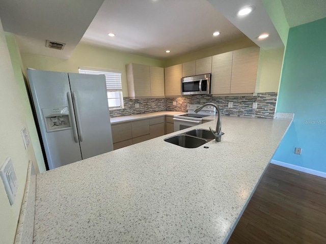2625 State Road 590 Unit 2514, Clearwater, FL 33759 - kitchen featuring white appliances, dark wood finished floors, tasteful backsplash, light countertops, and recessed lighting
