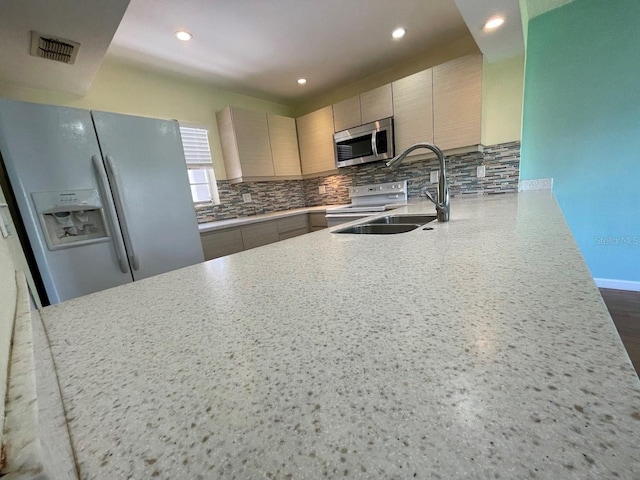 2625 State Road 590 Unit 2514, Clearwater, FL 33759 - kitchen featuring white appliances, decorative backsplash, light countertops, recessed lighting, and a peninsula