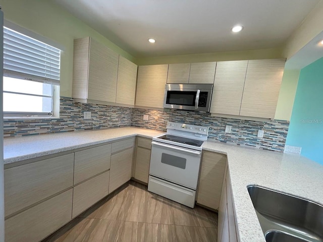2625 State Road 590 Unit 2514, Clearwater, FL 33759 - kitchen featuring stainless steel microwave, white range with electric cooktop, light countertops, backsplash, and recessed lighting