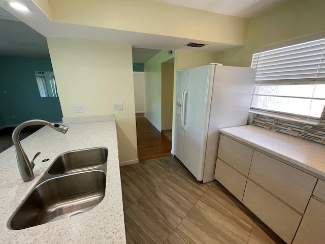 2625 State Road 590 Unit 2514, Clearwater, FL 33759 - kitchen featuring white refrigerator with ice dispenser, light countertops, and decorative backsplash