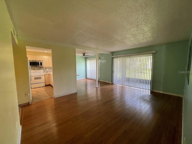 2625 State Road 590 Unit 2514, Clearwater, FL 33759 - unfurnished living room featuring wood finished floors, a textured ceiling, and ceiling fan