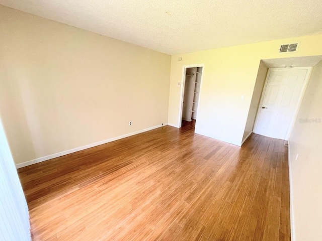 2625 State Road 590 Unit 2514, Clearwater, FL 33759 - spare room featuring light wood-style floors and a textured ceiling