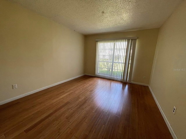 2625 State Road 590 Unit 2514, Clearwater, FL 33759 - spare room featuring dark wood-style floors and a textured ceiling