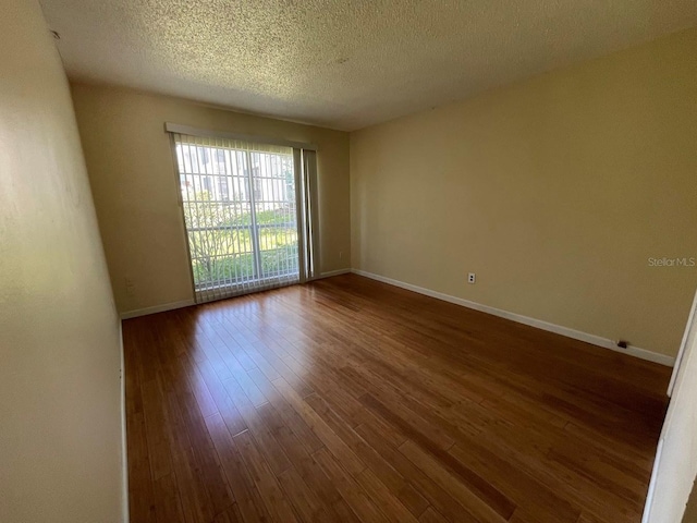 2625 State Road 590 Unit 2514, Clearwater, FL 33759 - empty room with dark wood-type flooring and a textured ceiling