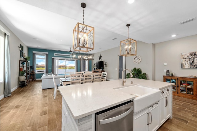 11714 Tetrafin Dr, Riverview, FL 33579 - kitchen with dishwasher, light wood-style flooring, a chandelier, open floor plan, and white cabinets