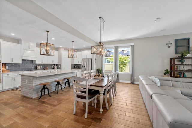 11714 Tetrafin Dr, Riverview, FL 33579 - dining area with a chandelier, recessed lighting, and light wood-type flooring