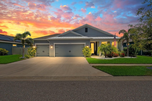 11714 Tetrafin Dr, Riverview, FL 33579 - view of front of house featuring a garage, concrete driveway, a standing seam roof, stucco siding, and a metal roof