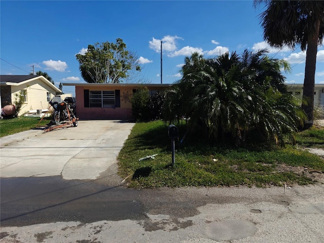13710 Frances Ave, Hudson, FL 34667 - view of front of house with driveway and brick siding