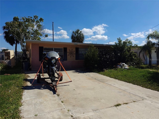 13710 Frances Ave, Hudson, FL 34667 - view of front facade with brick siding and driveway