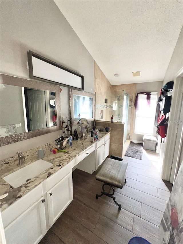 12603 Midpointe, Riverview, FL 33578 - full bath featuring a textured ceiling, a shower stall, wood finished floors, vanity, and vaulted ceiling