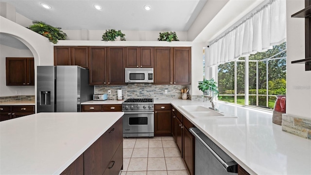 12439 Bristol Commons Cir, Tampa, FL 33626 - kitchen featuring stainless steel appliances, light countertops, recessed lighting, backsplash, and light tile patterned floors