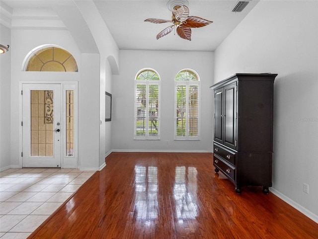 12439 Bristol Commons Cir, Tampa, FL 33626 - entrance foyer with ceiling fan, wood finished floors, and arched walkways