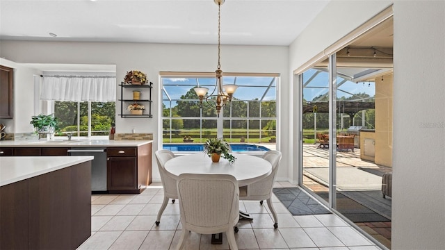 12439 Bristol Commons Cir, Tampa, FL 33626 - dining space featuring light tile patterned floors, plenty of natural light, and a chandelier