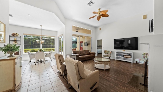 12439 Bristol Commons Cir, Tampa, FL 33626 - living area featuring ceiling fan, a chandelier, wood finished floors, and a towering ceiling