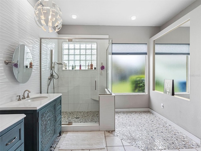 12439 Bristol Commons Cir, Tampa, FL 33626 - full bathroom with vanity, a shower stall, tile patterned floors, and a chandelier