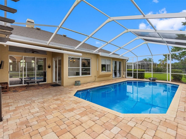 12439 Bristol Commons Cir, Tampa, FL 33626 - swimming pool with a patio, a ceiling fan, and glass enclosure
