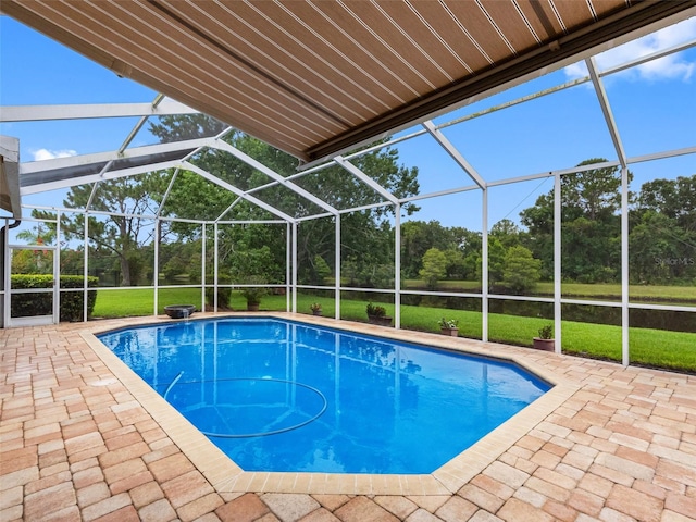 12439 Bristol Commons Cir, Tampa, FL 33626 - swimming pool featuring a patio area, view of wooded area, glass enclosure, and a yard