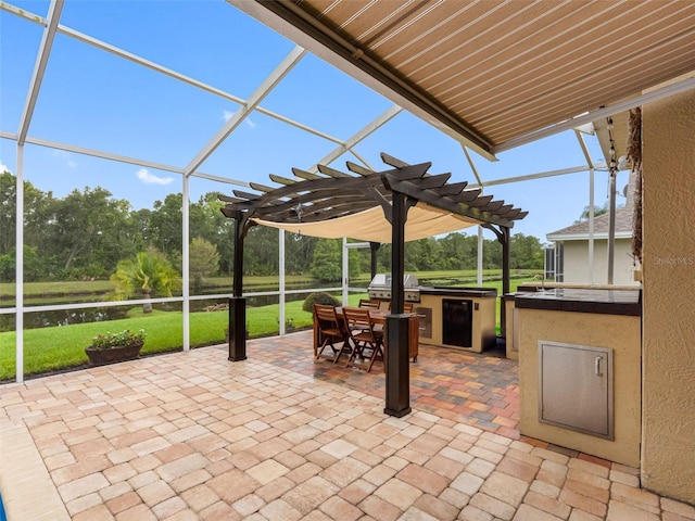12439 Bristol Commons Cir, Tampa, FL 33626 - view of patio with an outdoor kitchen, a pergola, a lanai, and view of wooded area