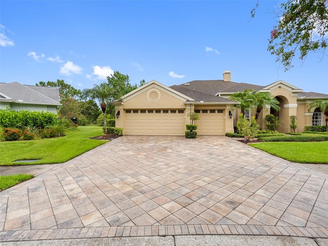 12439 Bristol Commons Cir, Tampa, FL 33626 - view of front of house with decorative driveway, an attached garage, a front lawn, stucco siding, and a chimney