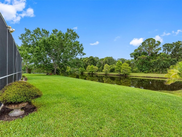 12439 Bristol Commons Cir, Tampa, FL 33626 - view of grassy yard with a water view and glass enclosure