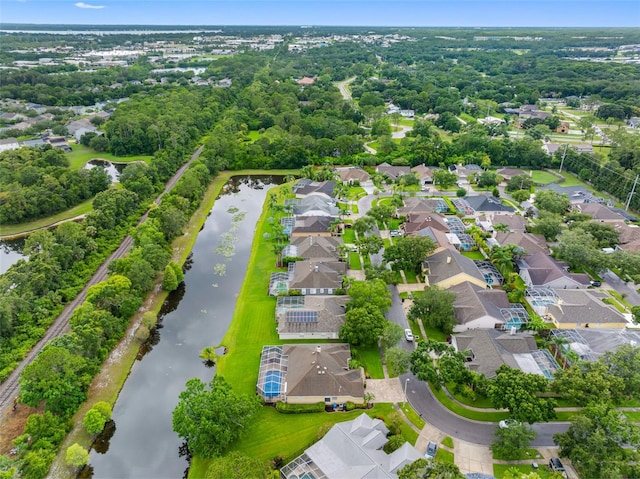 12439 Bristol Commons Cir, Tampa, FL 33626 - aerial view of residential area with a nearby body of water and a tree filled landscape
