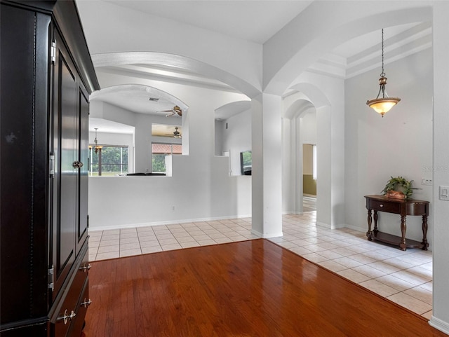 12439 Bristol Commons Cir, Tampa, FL 33626 - unfurnished living room with ceiling fan, light tile patterned floors, and arched walkways