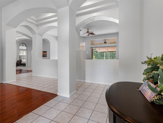 12439 Bristol Commons Cir, Tampa, FL 33626 - hallway featuring light tile patterned floors, plenty of natural light, and arched walkways