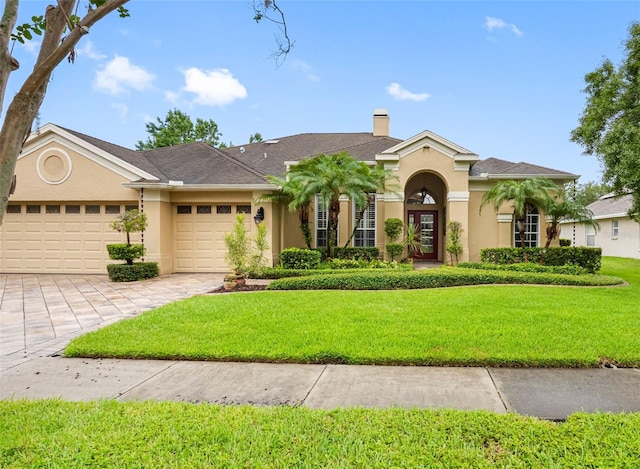 12439 Bristol Commons Cir, Tampa, FL 33626 - view of front of house featuring stucco siding, a garage, concrete driveway, and a front lawn
