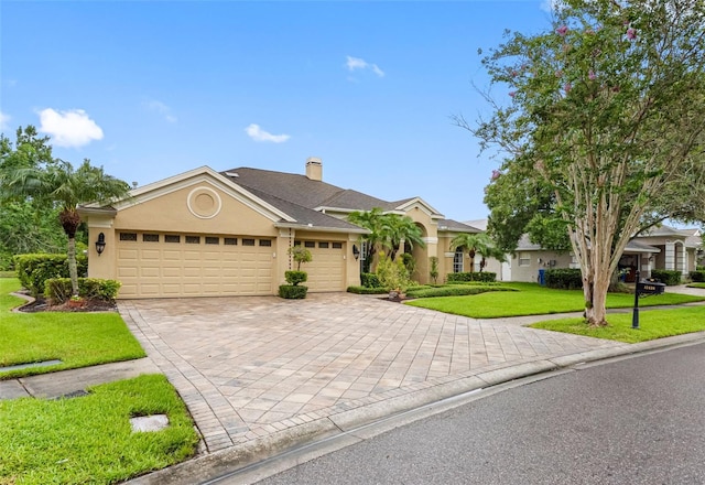 12439 Bristol Commons Cir, Tampa, FL 33626 - single story home with an attached garage, a front lawn, decorative driveway, stucco siding, and a chimney