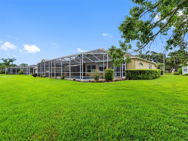 12439 Bristol Commons Cir, Tampa, FL 33626 - back of house with a yard, an outdoor pool, and a lanai