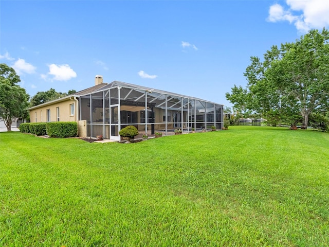 12439 Bristol Commons Cir, Tampa, FL 33626 - back of property featuring a chimney, a yard, and a lanai