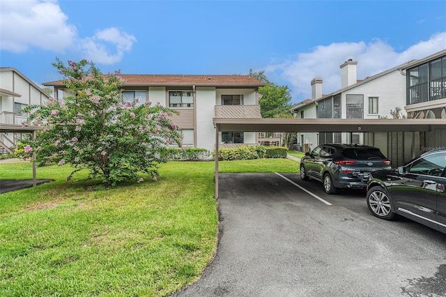 2368 Flanders Way Unit D, Safety Harbor, FL 34695 - view of building exterior featuring covered parking