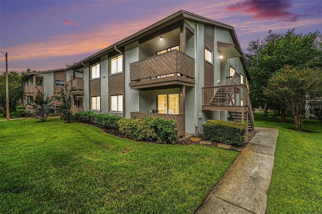 2368 Flanders Way Unit D, Safety Harbor, FL 34695 - view of front of house featuring a balcony, a front lawn, stairs, and stucco siding