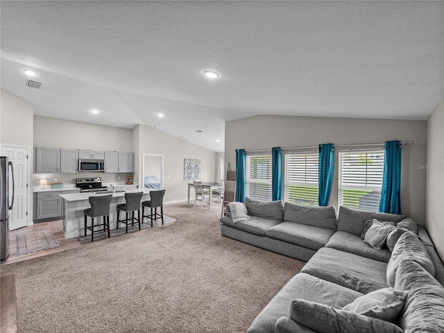 13105 Fruitville Way, Riverview, FL 33579 - living area featuring vaulted ceiling, light colored carpet, and recessed lighting