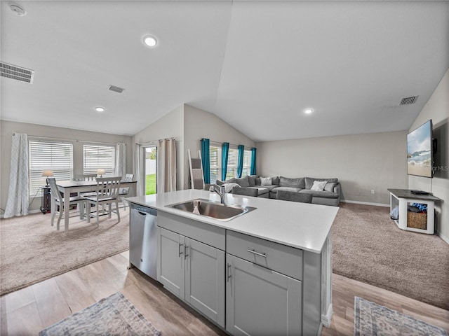 13105 Fruitville Way, Riverview, FL 33579 - kitchen featuring stainless steel dishwasher, gray cabinets, lofted ceiling, open floor plan, and a kitchen island with sink