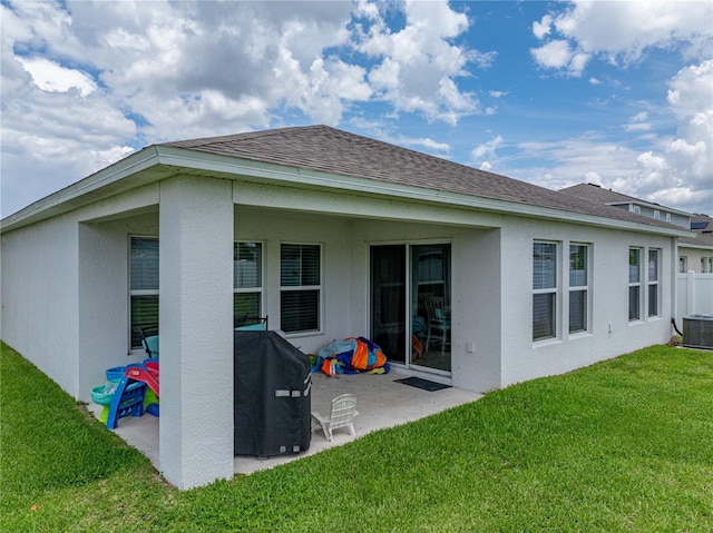 13105 Fruitville Way, Riverview, FL 33579 - rear view of property with a patio, a yard, stucco siding, and a shingled roof
