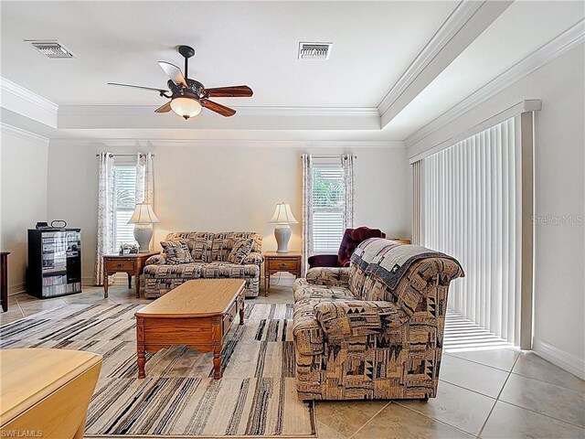 2103 SW 26th Ter, Cape Coral, FL 33914 - living room featuring a raised ceiling, healthy amount of natural light, ceiling fan, and crown molding