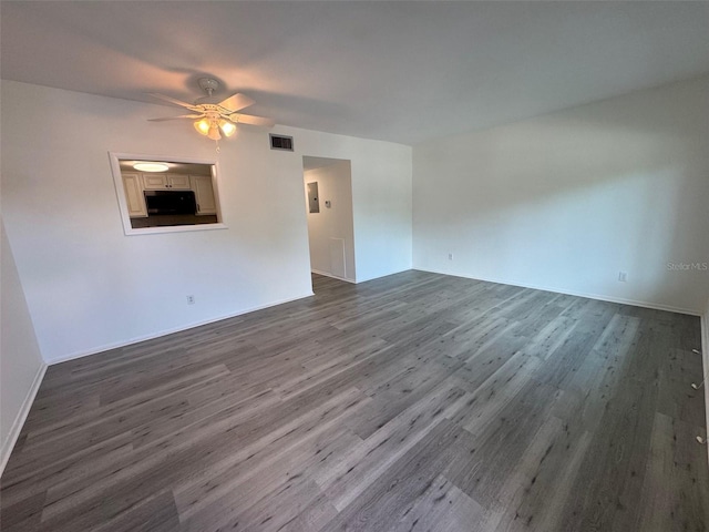 2459 Columbia Dr Unit 39, Clearwater, FL 33763 - unfurnished living room featuring dark wood-type flooring and ceiling fan