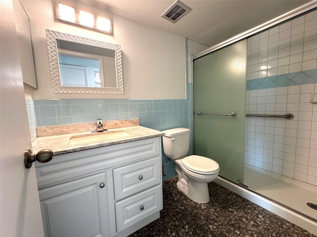 2459 Columbia Dr Unit 39, Clearwater, FL 33763 - bathroom featuring vanity, a shower stall, tile walls, and wainscoting
