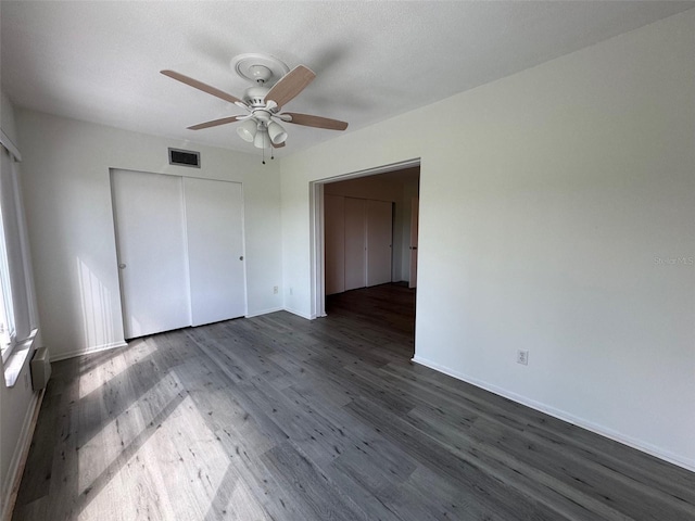 2459 Columbia Dr Unit 39, Clearwater, FL 33763 - unfurnished bedroom featuring dark wood-style flooring, a closet, and ceiling fan