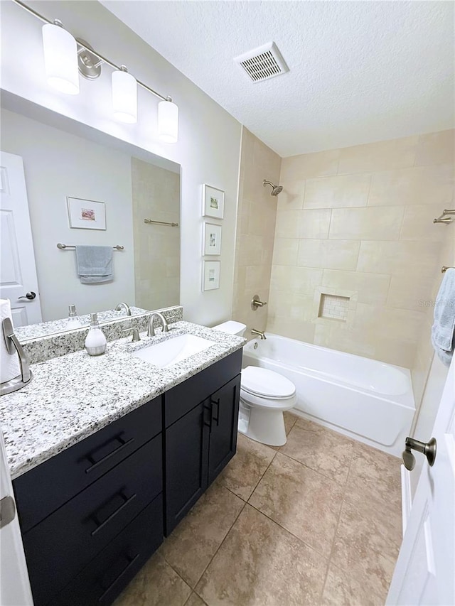 663 Jamaica Cir, Lakeland, FL 33803 - full bathroom featuring vanity, tub / shower combination, tile patterned flooring, and a textured ceiling