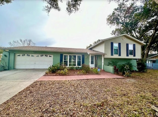 2014 Nancy Ave, Lutz, FL 33548 - split level home with an attached garage, concrete driveway, and stucco siding