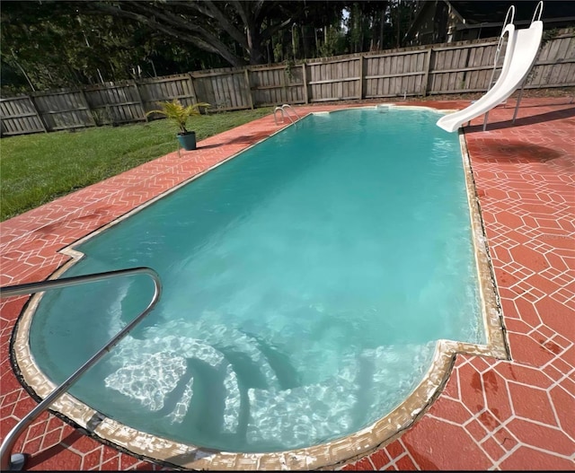 2014 Nancy Ave, Lutz, FL 33548 - view of swimming pool featuring a water slide, a fenced backyard, and a patio area