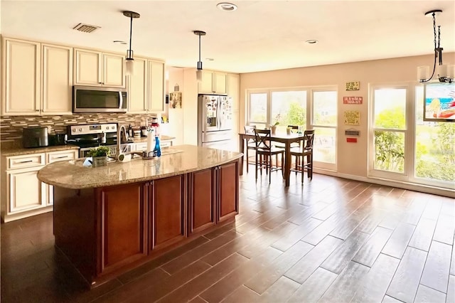 2014 Nancy Ave, Lutz, FL 33548 - kitchen with stainless steel microwave, fridge with ice dispenser, cream cabinets, electric range oven, and recessed lighting
